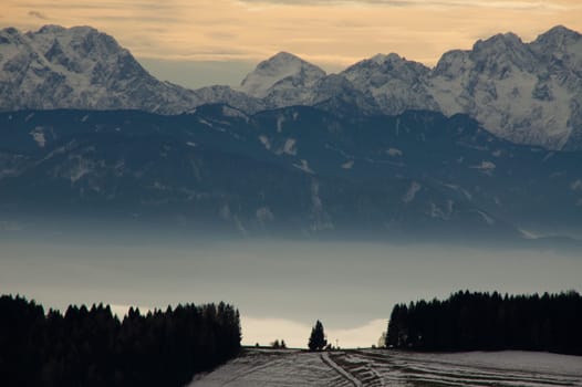 The Austrian Alps can be seen in a clearing and on the horizon