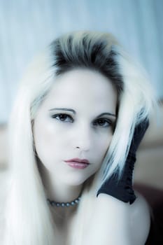sexy blond woman posing with a cool blue hue
