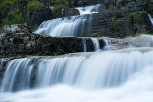 some huge water cascades running down some stones