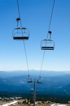 Chairlift running down Mount Hood with Mount Jefferson visible in the background