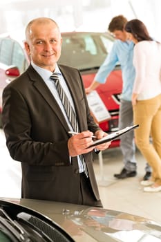 Closeup portrait of salesman working in car dealership