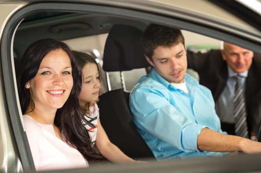 Caucasian family sitting in car in retail store