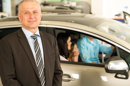 Closeup portrait of car dealer looking at camera