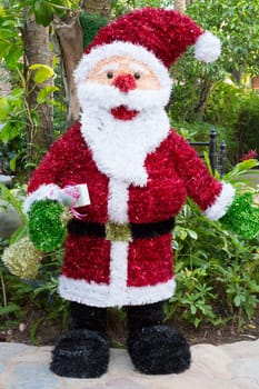 Santa Claus figure on the background of tropical trees