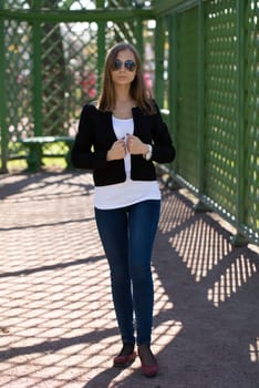 young trendy beautiful girl with sunglasses in a greenhouse