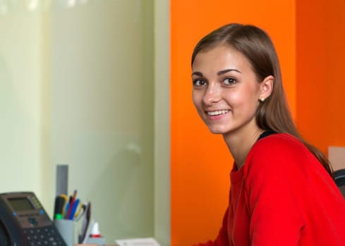 Beautiful girl in bright clothes at your desk