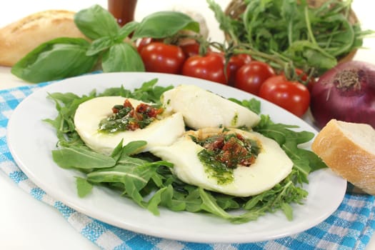stuffed mozzarella on a bed of rocket against a white background