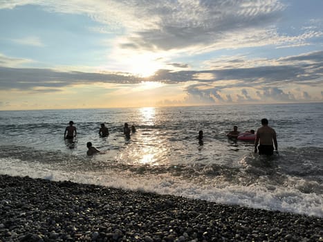 Sea water sunset sky landscape Batumi Georgia beach background blue nature orange light wallpaper evening travel people white clouds . High quality photo