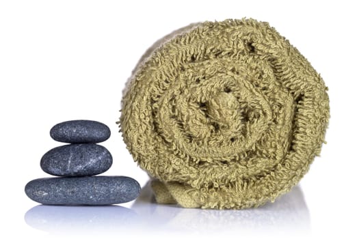 Spa stones and towel on white background. Spa concept. Macro shot