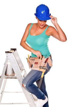 A woman wearing a DIY tool belt full of a variety of useful tools on a white background.