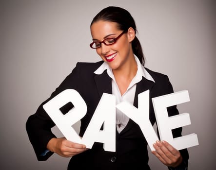 Income tax concept with a beautiful businesswoman holding letters spelling out P.A.Y.E. that stands for pay as you earn.