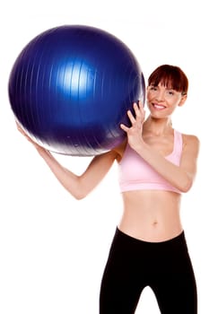 A fitness woman doing exercises with a blue gym ball