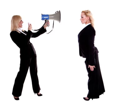 A beautiful blond businesswoman shouting trough a megaphone at herself.