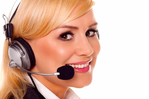 A beautiful young woman talking on a headset in a call centre