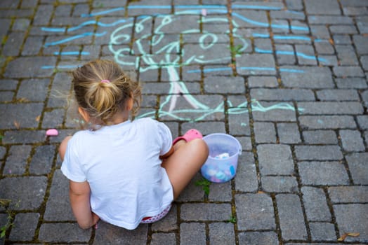 child is painting the street