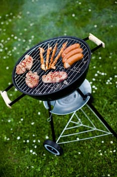 Grilling meat in flames, tasty dinner