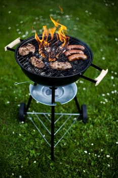 Grilling meat in flames, tasty dinner