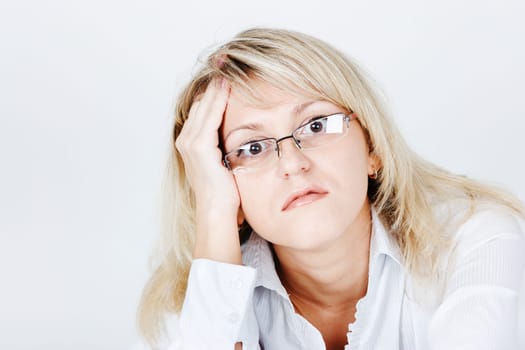 Tired of attractive young blond woman in glasses. portrait