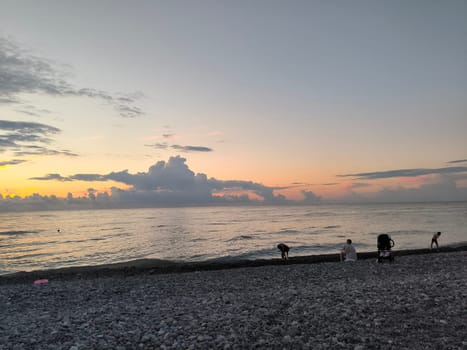 Sea water sunset sky landscape summer Batumi Georgia beach background blue nature orange light wallpaper evening travel people white clouds . High quality photo