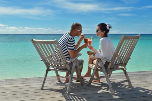 happy young couple relax and take fresh drink at summer vacation