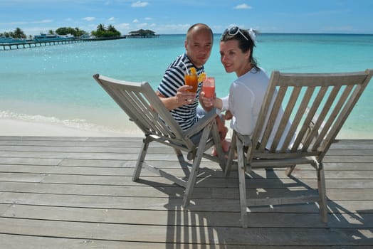 happy young couple relax and take fresh drink at summer vacation
