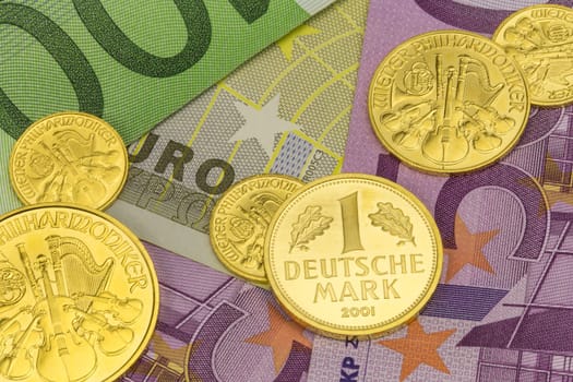 various gold coins on euro banknotes