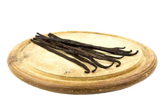 Vanilla pods on a wooden board