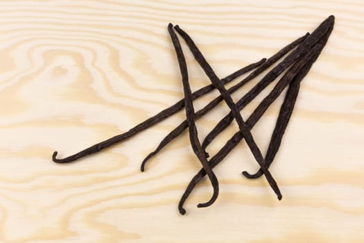 Vanilla pods on a wooden board