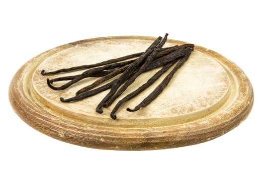 Vanilla pods on a wooden board