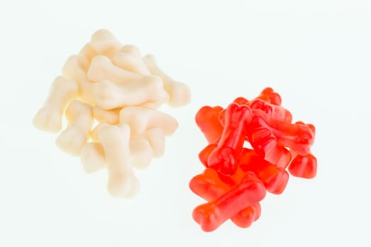 Red and cream gummy bones candy close-up