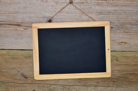 Slate on wooden background