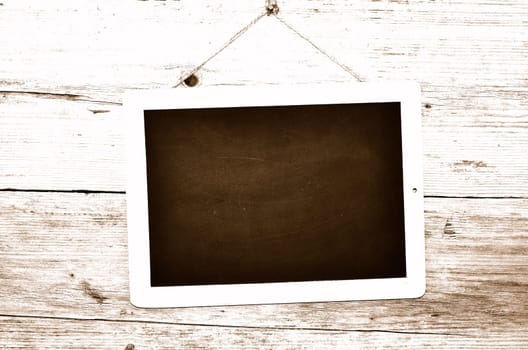 Slate on wooden background