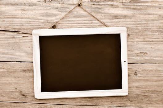 Slate on wooden background