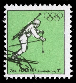 AJMAN - CIRCA 1972: A stamp printed in Ajman shows biathlonist, circa 1972