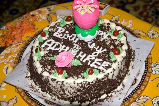 Decorated cake with flowers and candles for birthday celebration