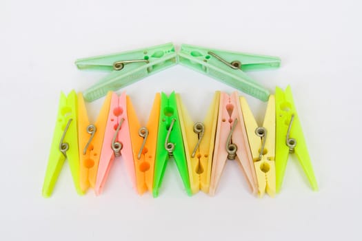 Arrangement of colorful cloth drying clips, isolated on white