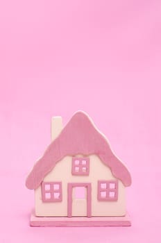 Pink house in front of pink background with text space for advertising