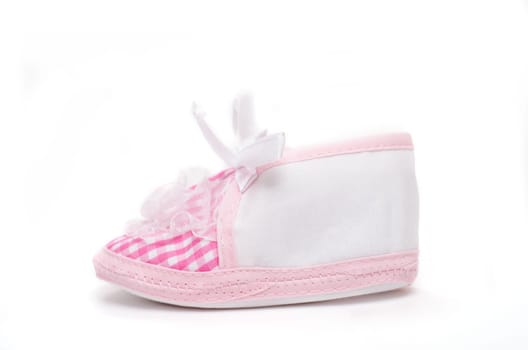 Pink baby shoe on white background