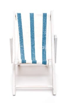 Deckchair with blue and white stripes against a white background