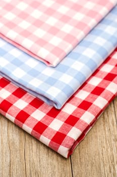 Close-up of checkered fabrics on a wooden table