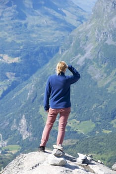 A Woman Looking or Searching efter Something on the Pike of a Mountain