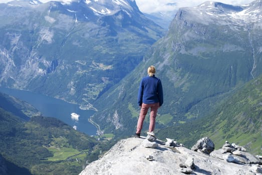 A Woman Enjoying a Panoramatic View Over Geiranger Fjord in Norway