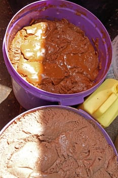 Two large plastic containers full of handmade peanut butter