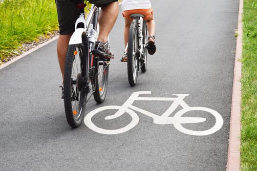 Bicycle road sign and bike riders