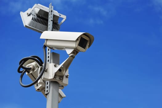 Hi-tech dome type camera over a blue sky