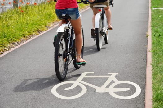 Bicycle road sign and bike riders