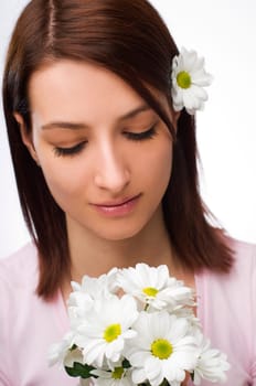 Beautiful young woman with flowers close up