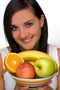young brunette girl holding bowl with fruit close up