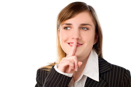 Young brunette woman with her finger over her mouth