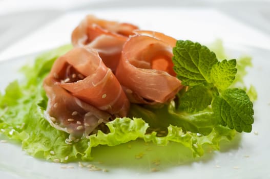 Prosciutto snack with sesame seeds close up